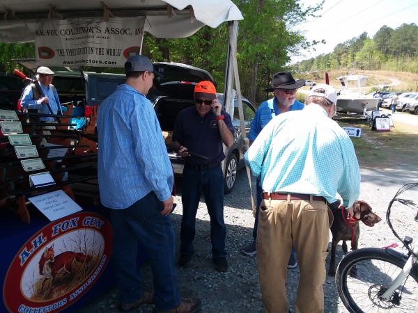 Members Tom Tutwiler (c.) and Allen Petersen (r.) help examine a gun